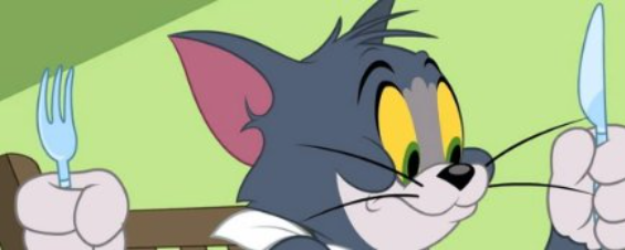 Tom the cat holding a fork and knife, ready for a meal